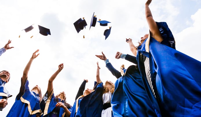 Recent graduates tossing their mortarboards